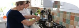 Crown Care worker with a service-user making food in their kitchen at home
